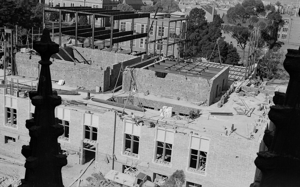 University building under construction from ridge of Wilson Hall.