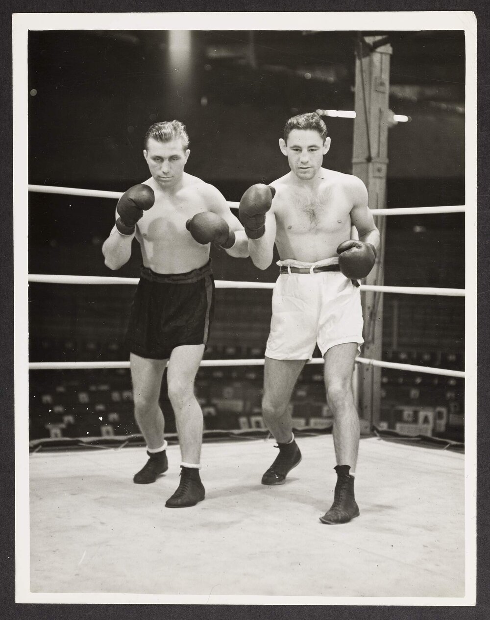 [Two unnamed boxers in the ring]