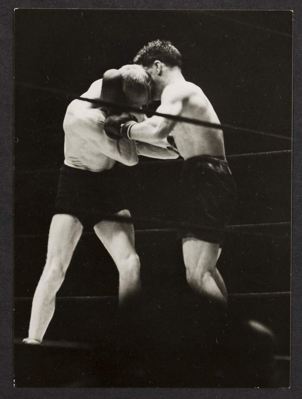 Two unidentifiable boxers in the ring