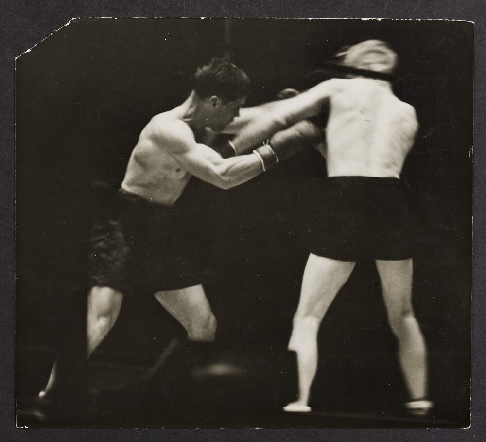 [Two boxers during a fight]