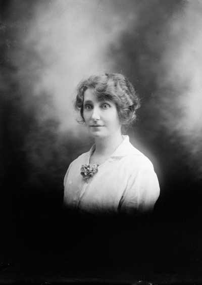 Studio half-length portrait of a woman.