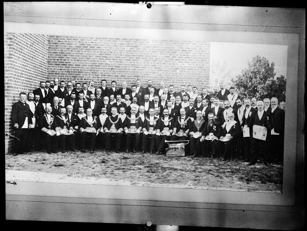A large group of men, possibly dressed in Masonic regalia.
