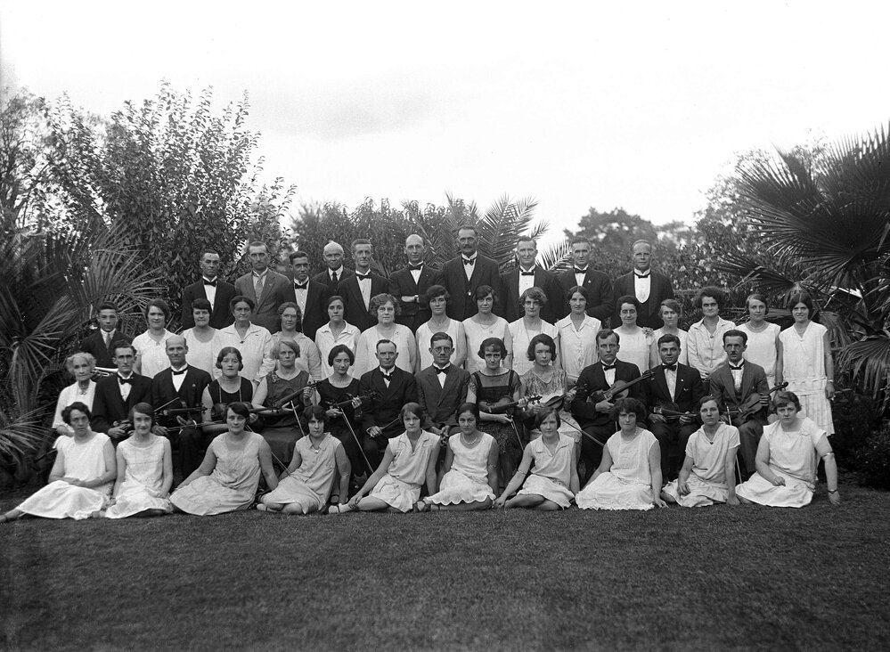 A posed group of musical performers, either the Benalla Musical Society or Mona Rahilly Orchestra.