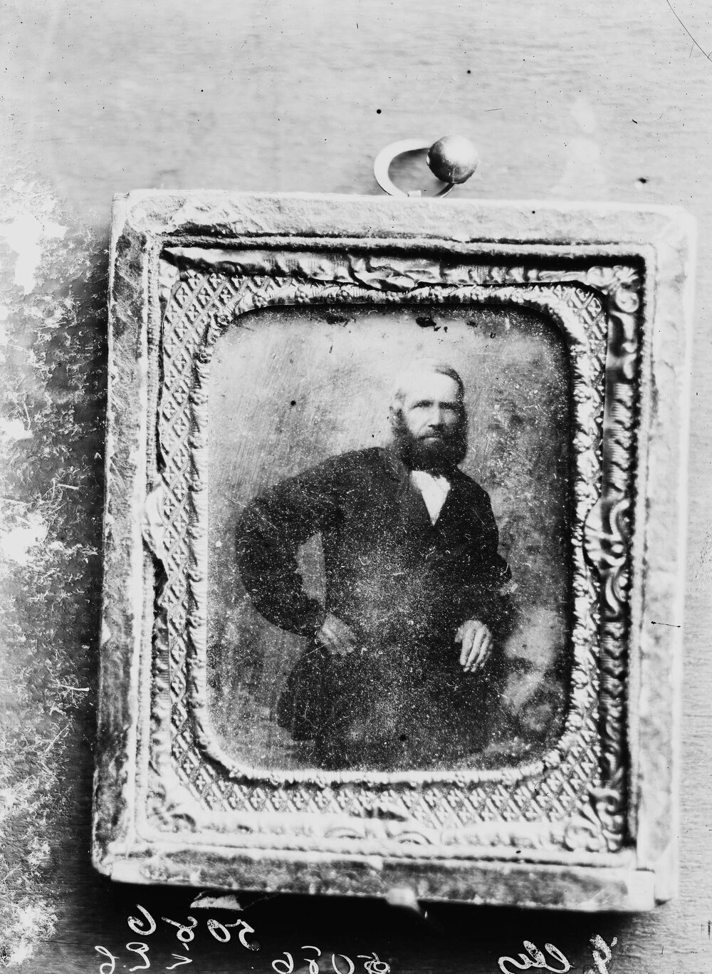 A framed portrait of an unidentified standing man.