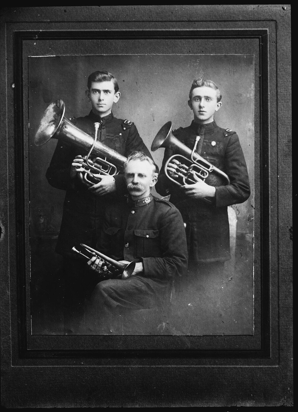 Three unidentified bandsmen in uniform.