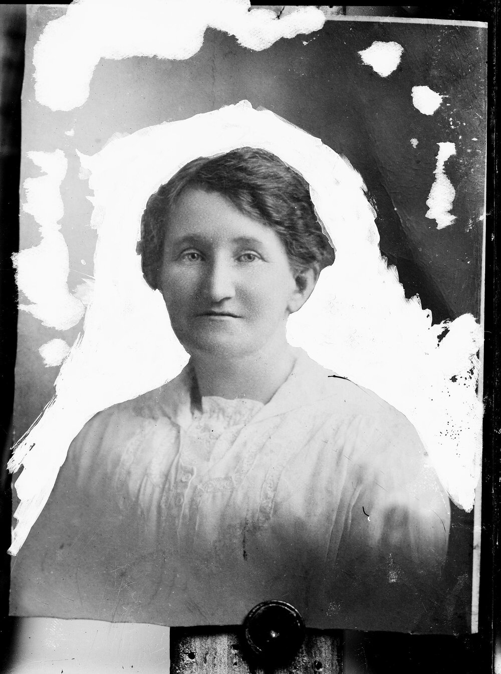 Portrait of an unidentified woman in a white blouse.