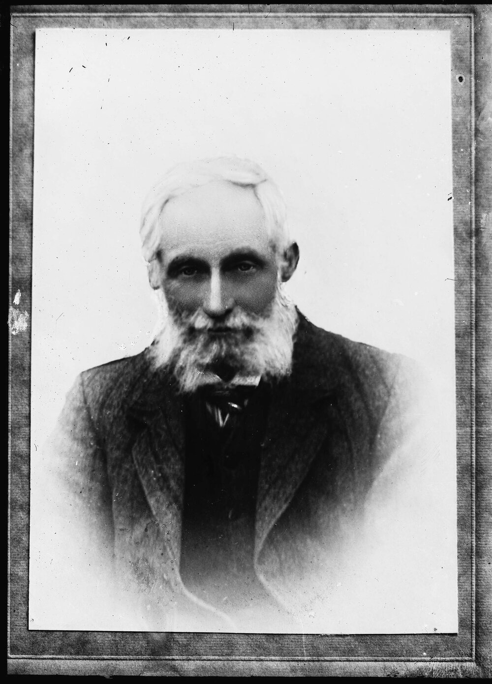An unidentified man with white hair and unkempt beard.