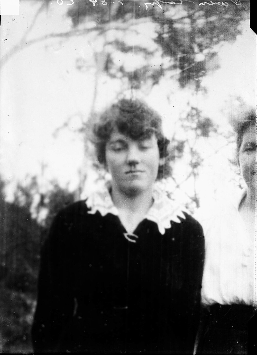 A half-length view of a young woman.
