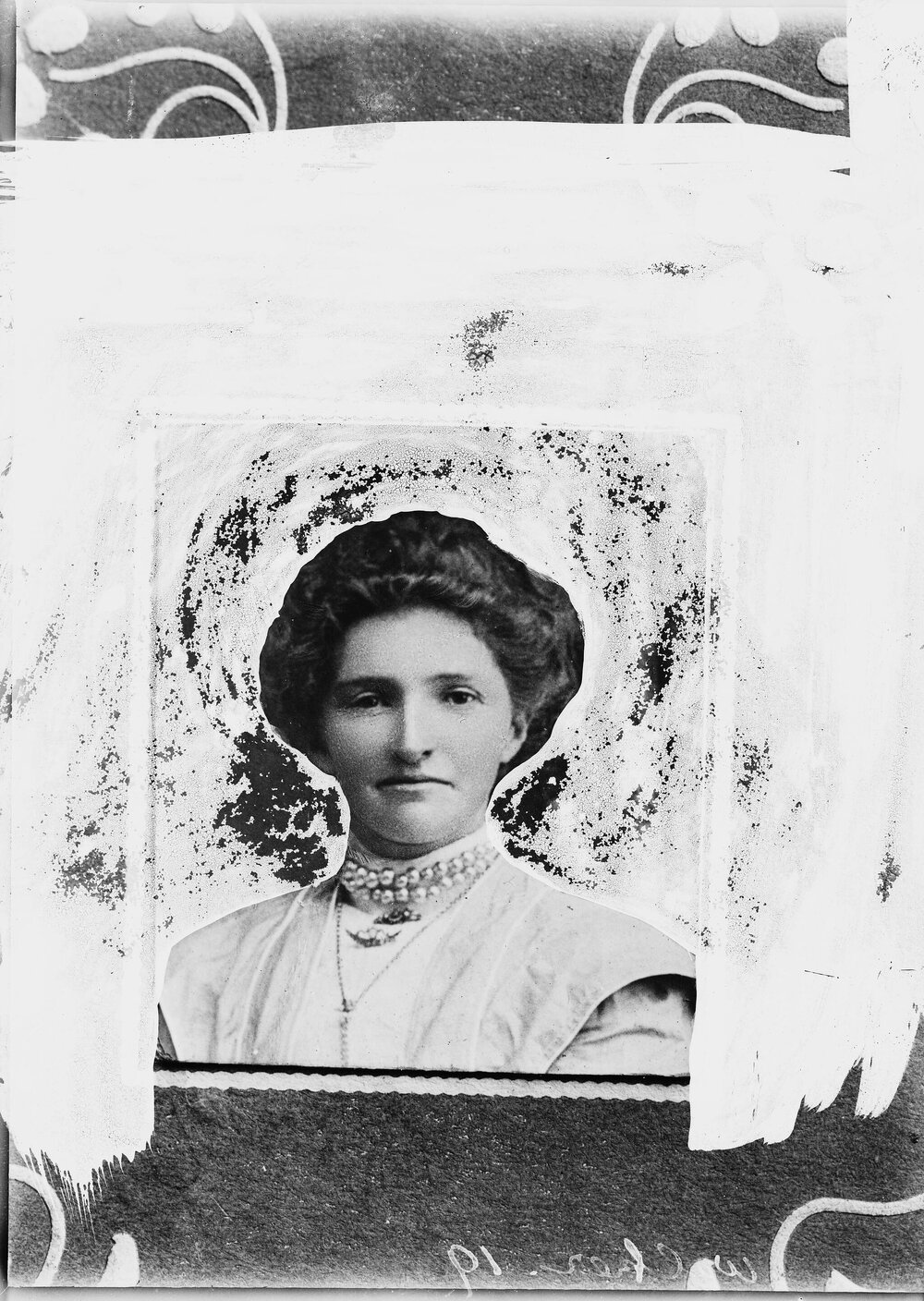 Portrait of an unidentified woman wearing a double strand pearl necklace.