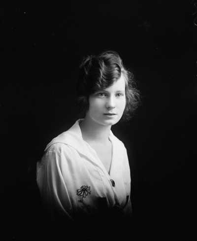 Studio half-length portrait of a young woman.
