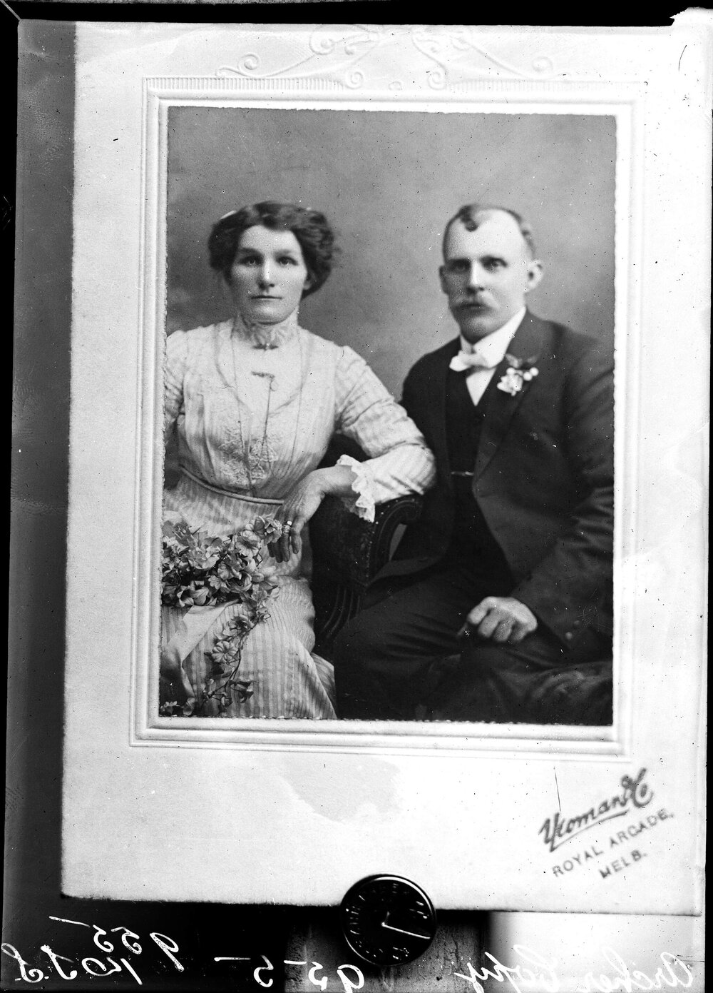 Studio portrait of a seated man and woman.