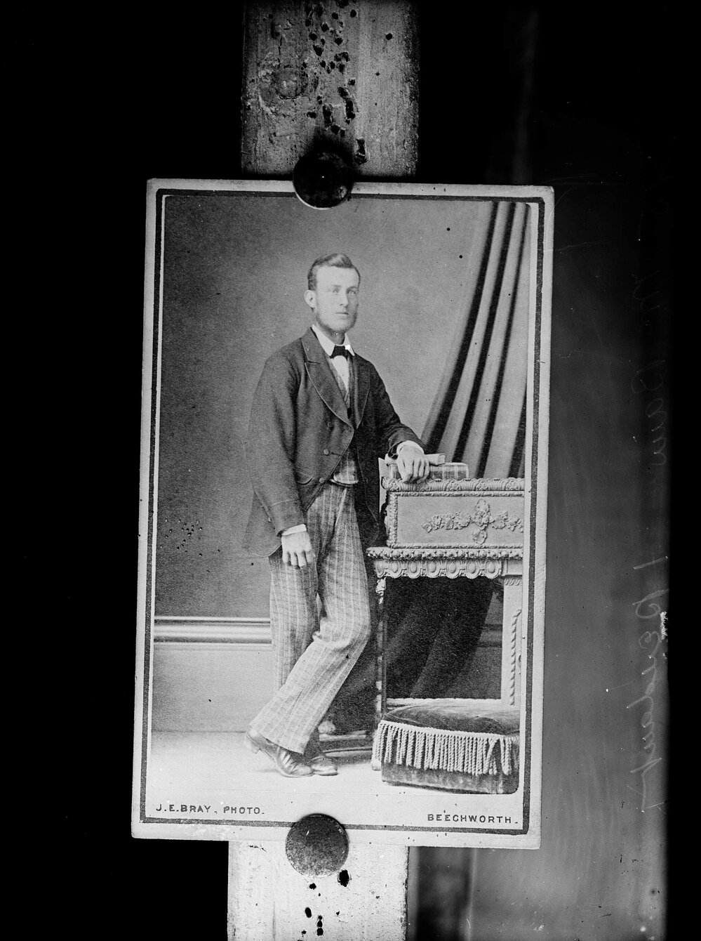 Portrait of an unidentified man wearing check trousers.