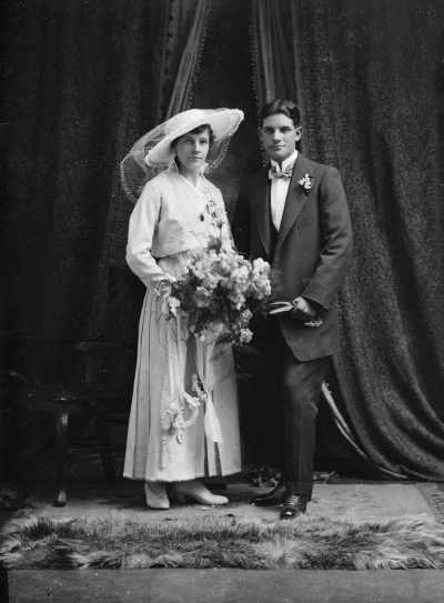 Studio portrait of a bride and groom.  Family name Warne.