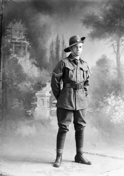 Studio portrait of a young man in an army style uniform.  Family name Fordham.