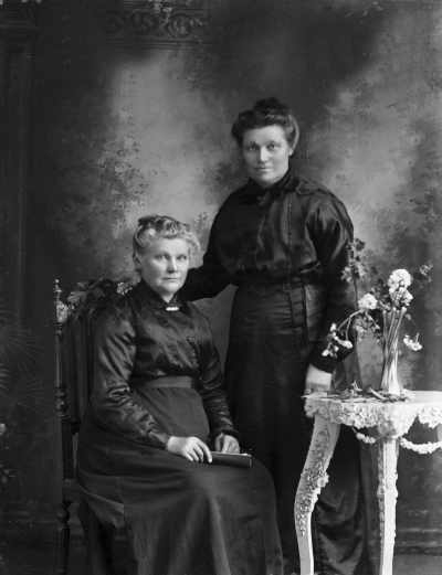 Studio portrait of two woman.  Family names Kirby and Horrigan.