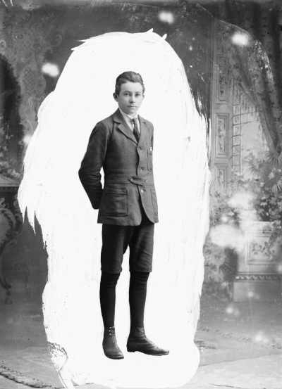 Portrait of a young man in jacket, short pants and tie. Family name Young.