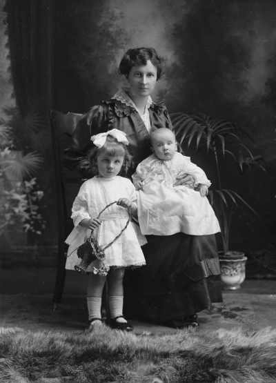 Studio portrait of Mrs. Smith with two children.