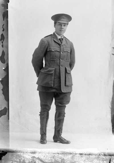 Studio portrait of Miss Cameron in an army style uniform and a YMCA cap.