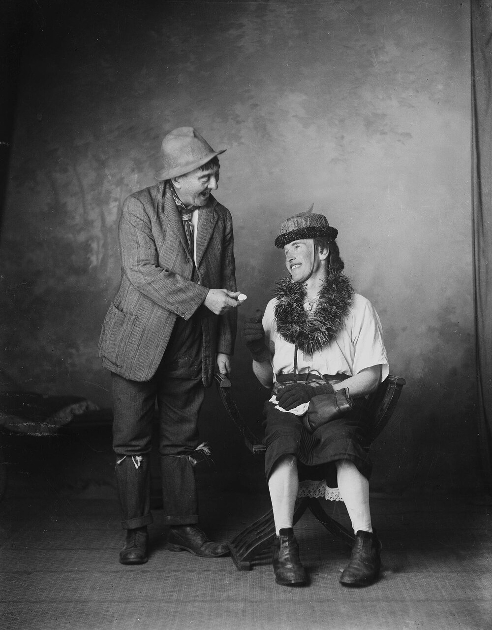 Two unidentified people in costume in a studio.