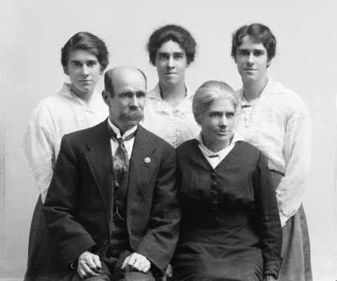 A seated man and woman with three younger women standing behind.  Family name Casson.