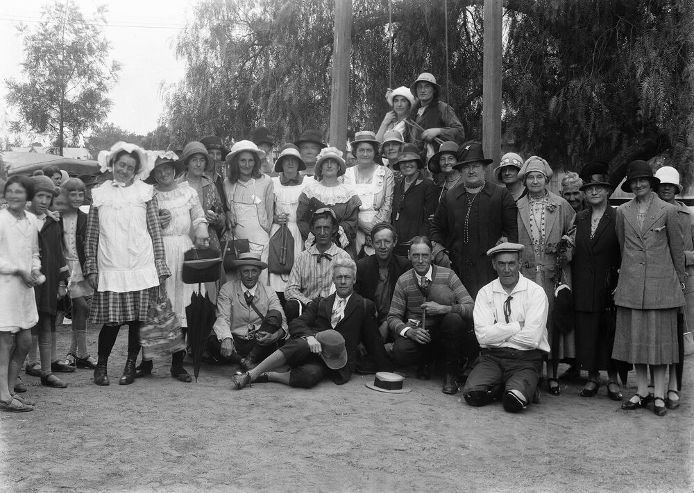 An outdoor posed group of about fifty happy people.