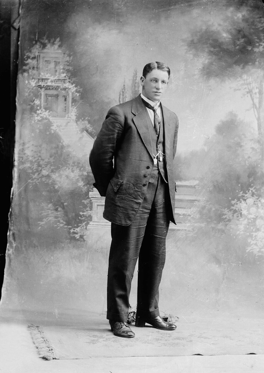 Studio portrait of a man wearing a crumpled suit.  Family name possibly Lee.