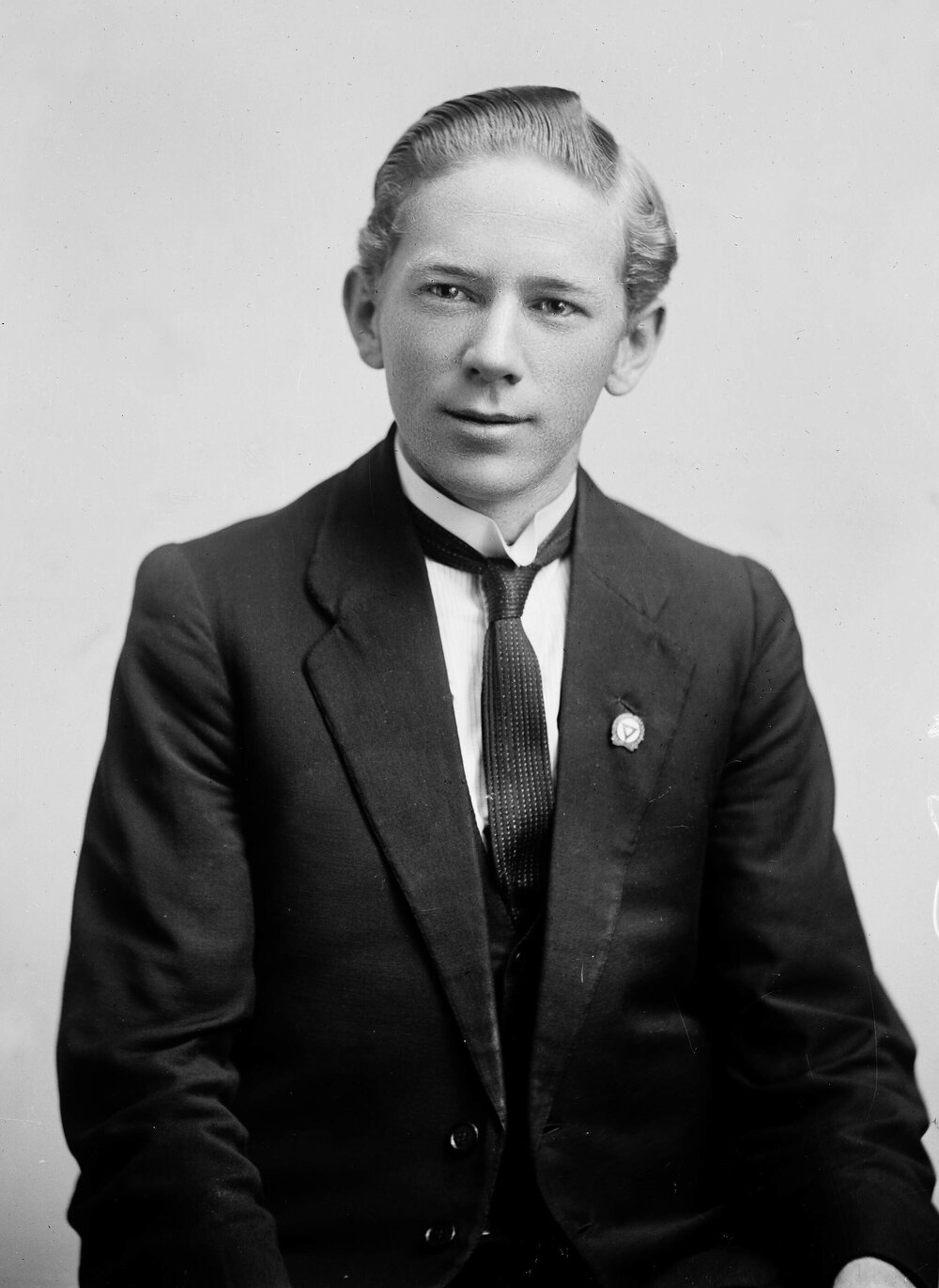 Studio portrait of a young man in a three-piece suit.  Family name possibly Bowman.