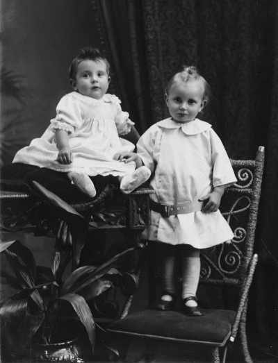 Studio portrait of  a young girl and a baby.  Family name Reeves.