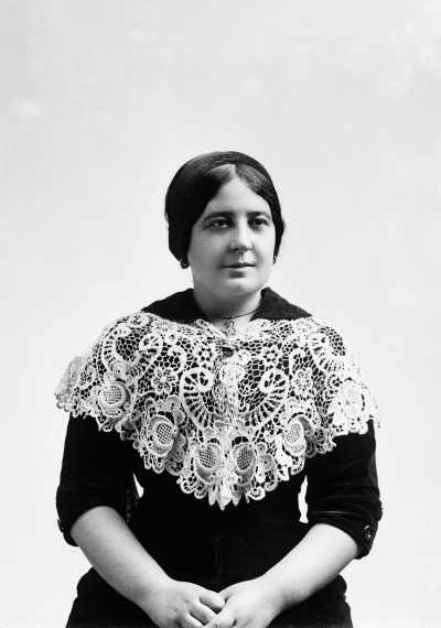 Portrait of Miss Ross wearing a dark dress and large lace collar.