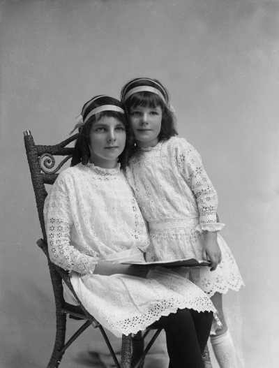 Portrait of two girls in similar dresses.  Family name Connellan.