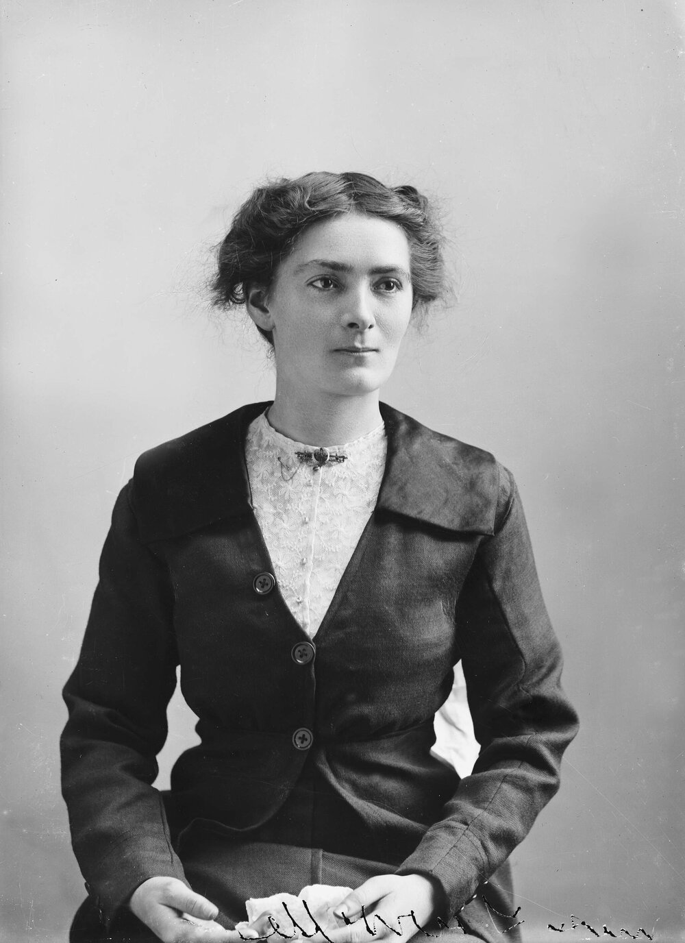 Studio portrait of  a young woman wearing a suit.
