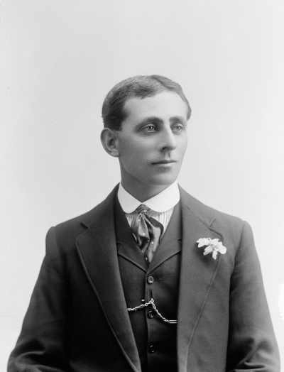 Portrait of a young man wearing a suit.  Family name Pearce.