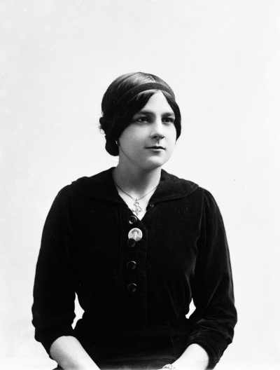 Portrait of Miss F. Ross wearing a dark dress.