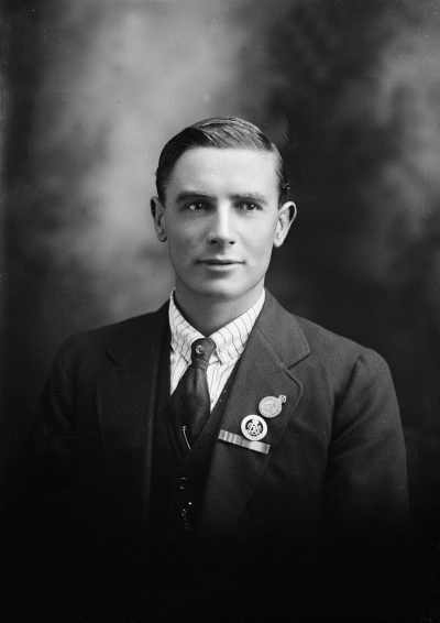 Studio portrait of Mr. Harris wearing armed services medals.