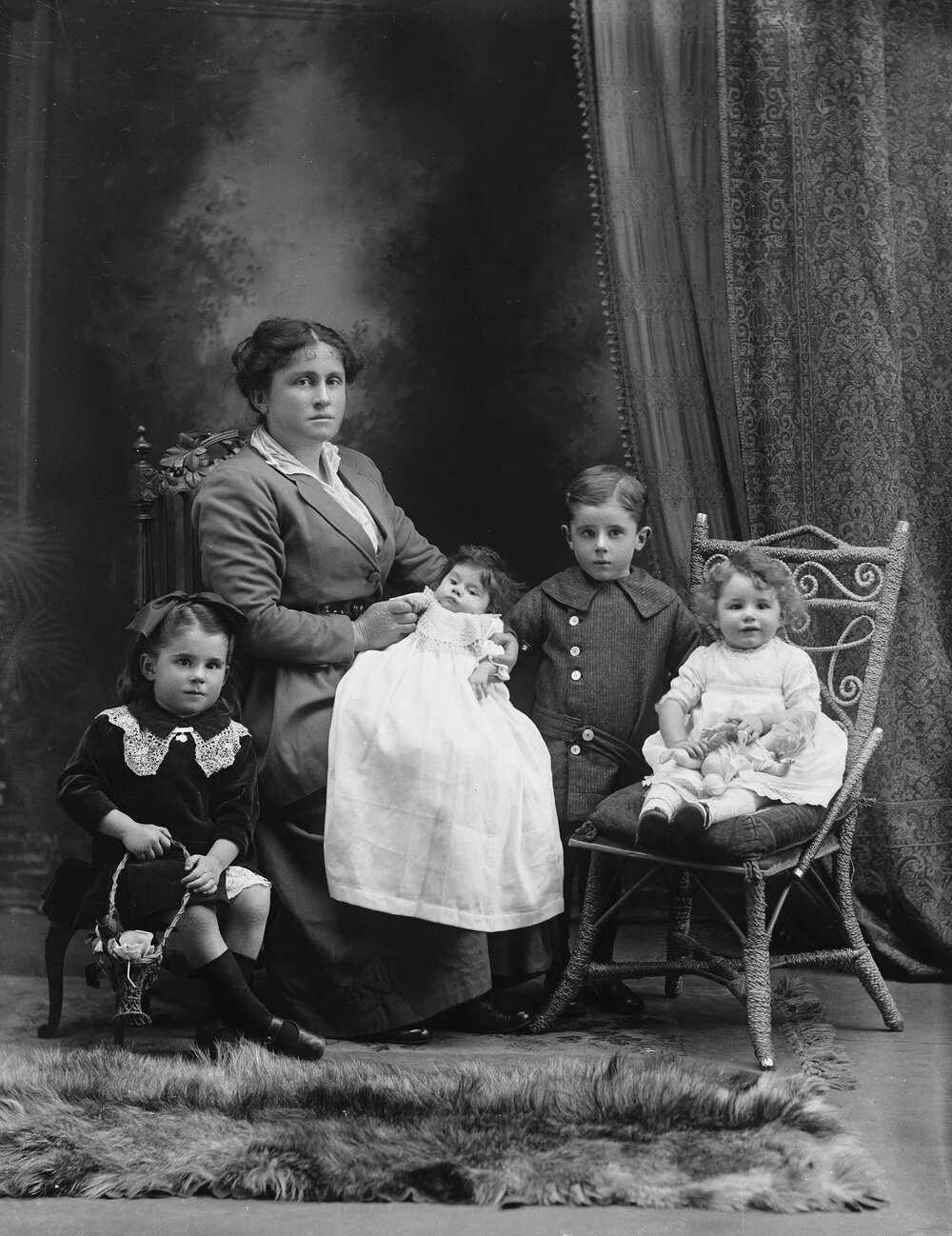 Studio portrait of a woman with four young children.