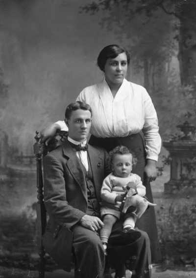 Studio portrait of a man, a woman and a baby.  Family name Garbutt.