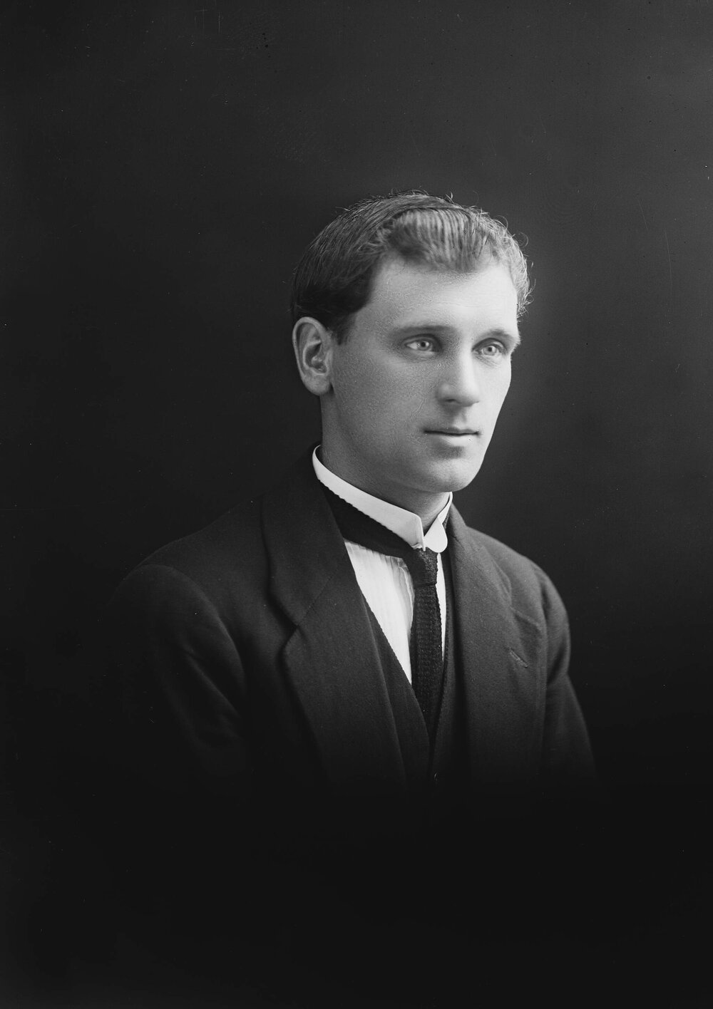 Studio portrait of a young man in a three-piece suit.  Family name possibly Fletcher.