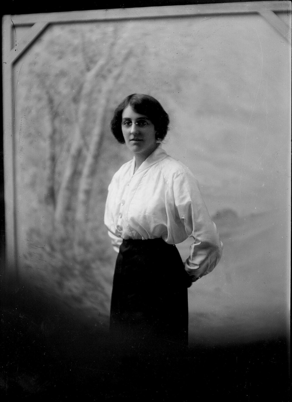 Indoor portrait of a standing woman.  Family name possibly Wallace.