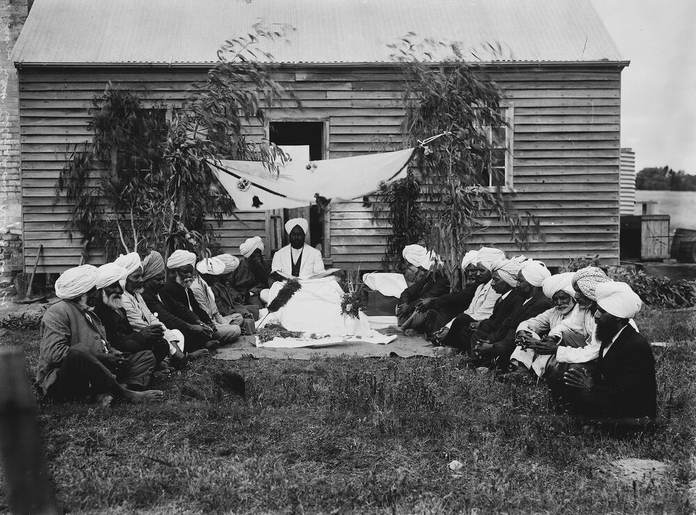 A group of Indian men, possibly Sikhs, outside a timber cottage at Reef Hills near Benalla.