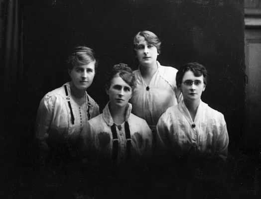 Studio group portrait of four women.