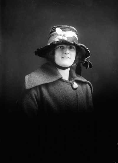 Studio portrait of Miss Williams in a fruited hat.