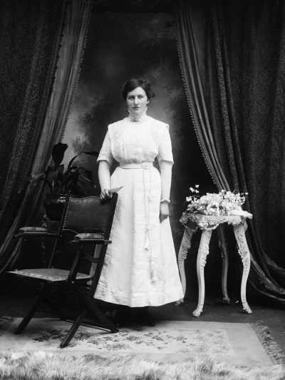 Portrait of an unidentified woman wearing a long white dress.