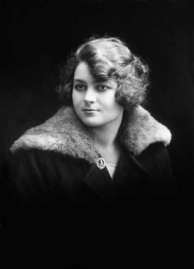 Studio portrait of Miss Samuels wearing a fur trimmed coat.