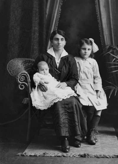 Studio portrait of a woman and two children.  Family name Winrow.