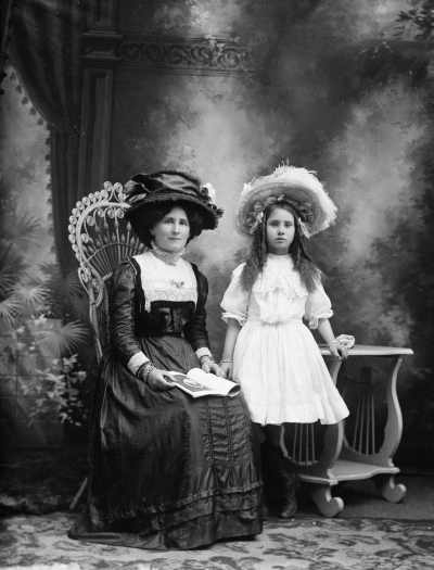 Studio portrait of a woman and a girl.  Family name Newson.