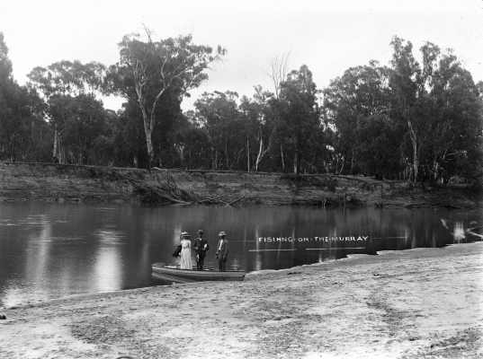 A woman and two men fishing at the Murray River, Victoria.