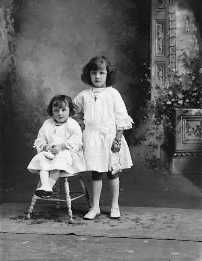 Studio portrait of two young girls.   Family name Clark.