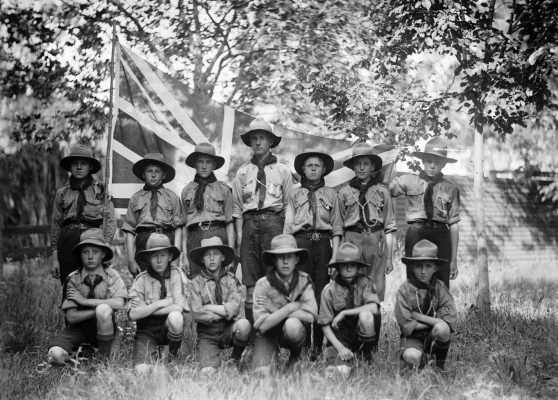 An unidentified group of Boy Scouts in front of a Union Jack.