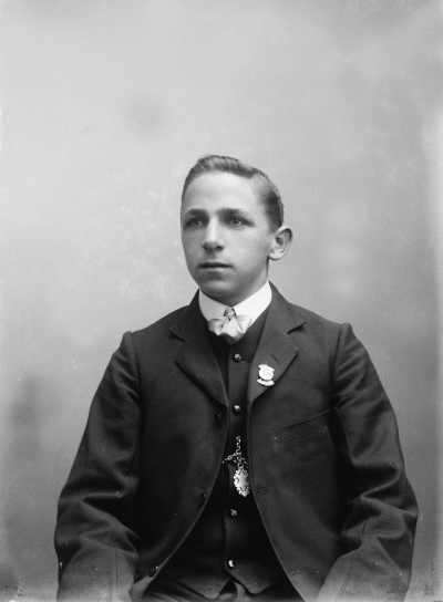 Studio portrait of a young man in a three piece suit.  Family name Wood.