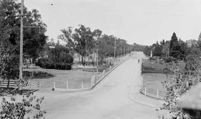 A view, looking West, of the concrete road bridge and the Broken River at Benalla.